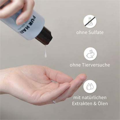 Hand drückt weißes Shampoo aus PUR HAIR Magic Keratin Flasche, Produktmerkmale: ohne Sulfate, ohne Tierversuche mit natürlichen Extrakten & Ölen